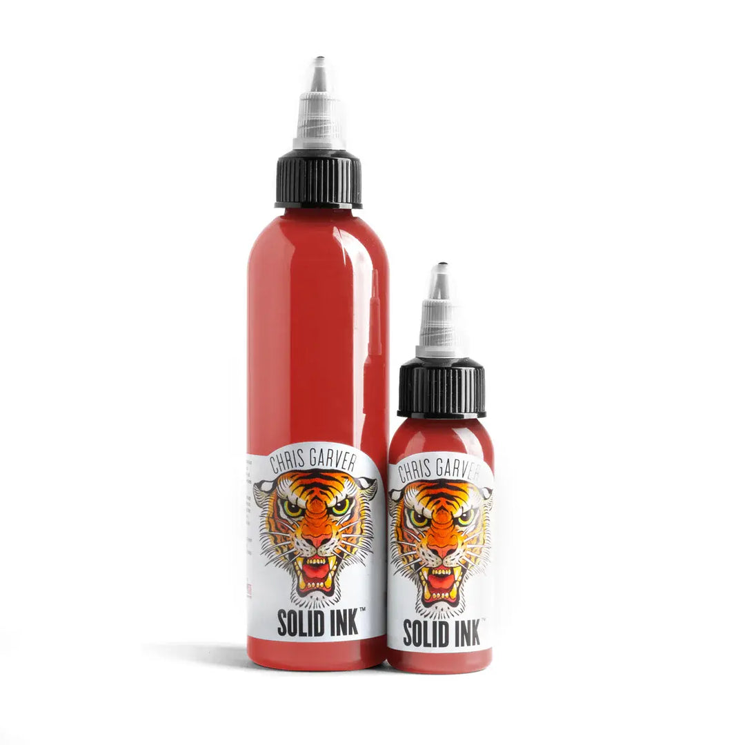 Two bottles of Chris Garver Solid Ink with tiger design on a white background