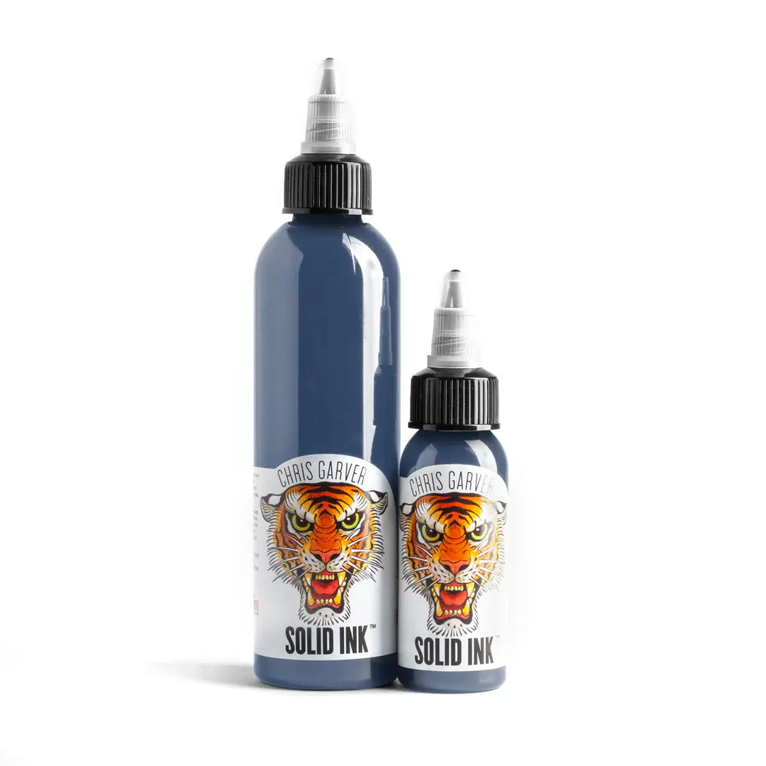 Two bottles of Chris Garver Solid Ink with tiger design labels on a white background