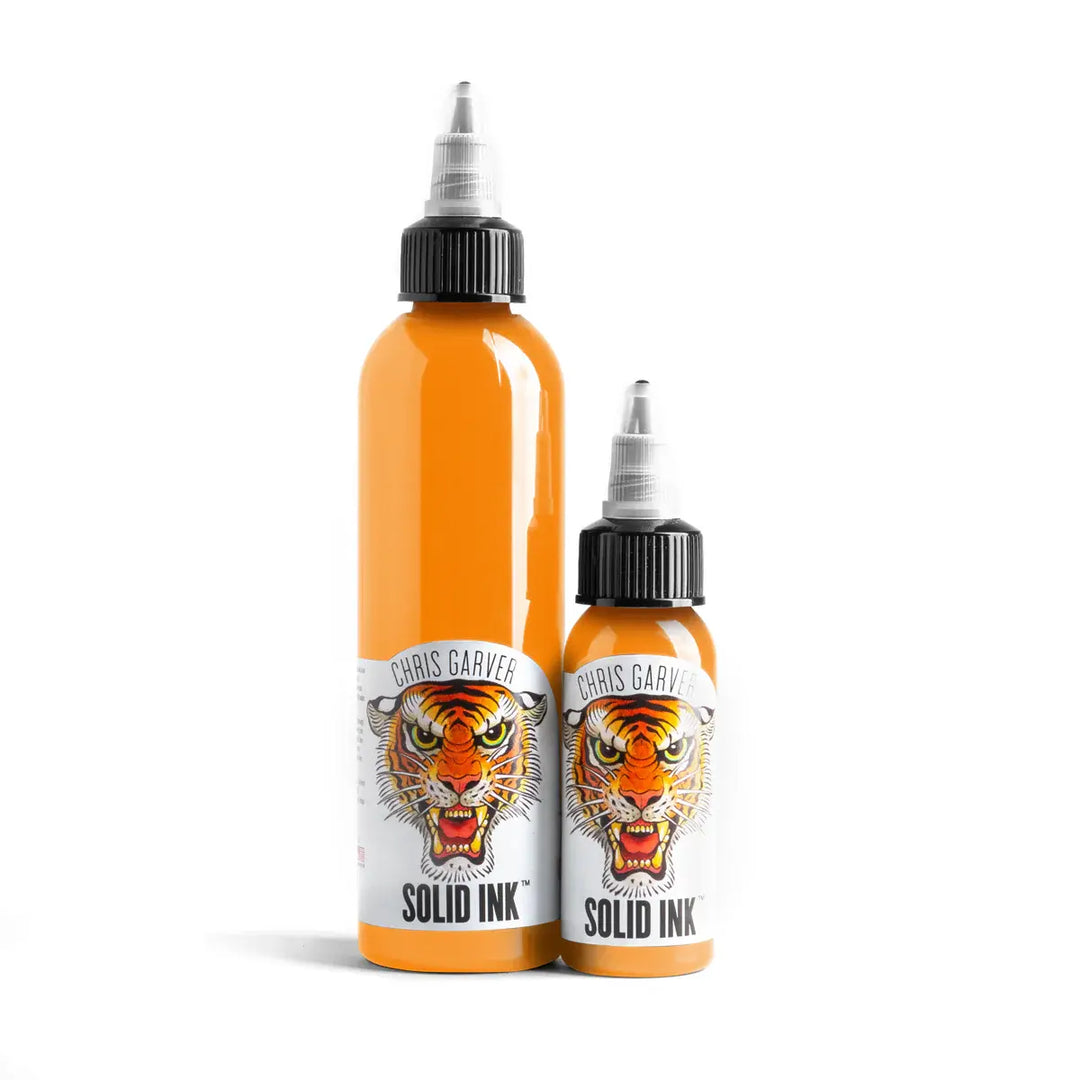 Two bottles of Chris Garver Solid Ink with tiger design labels on a white background