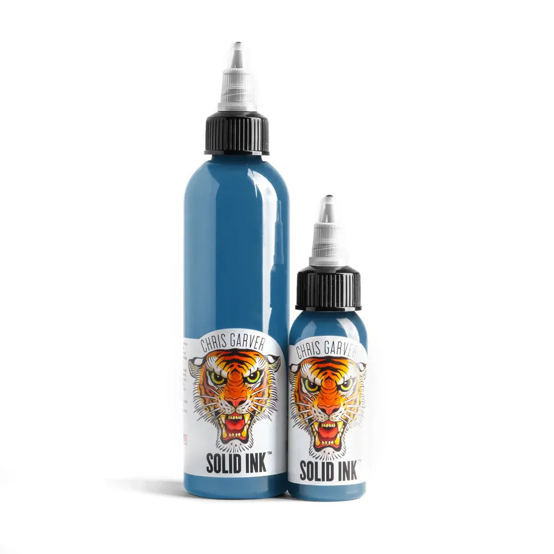 Two bottles of Chris Garver Solid Ink with tiger design on a white background