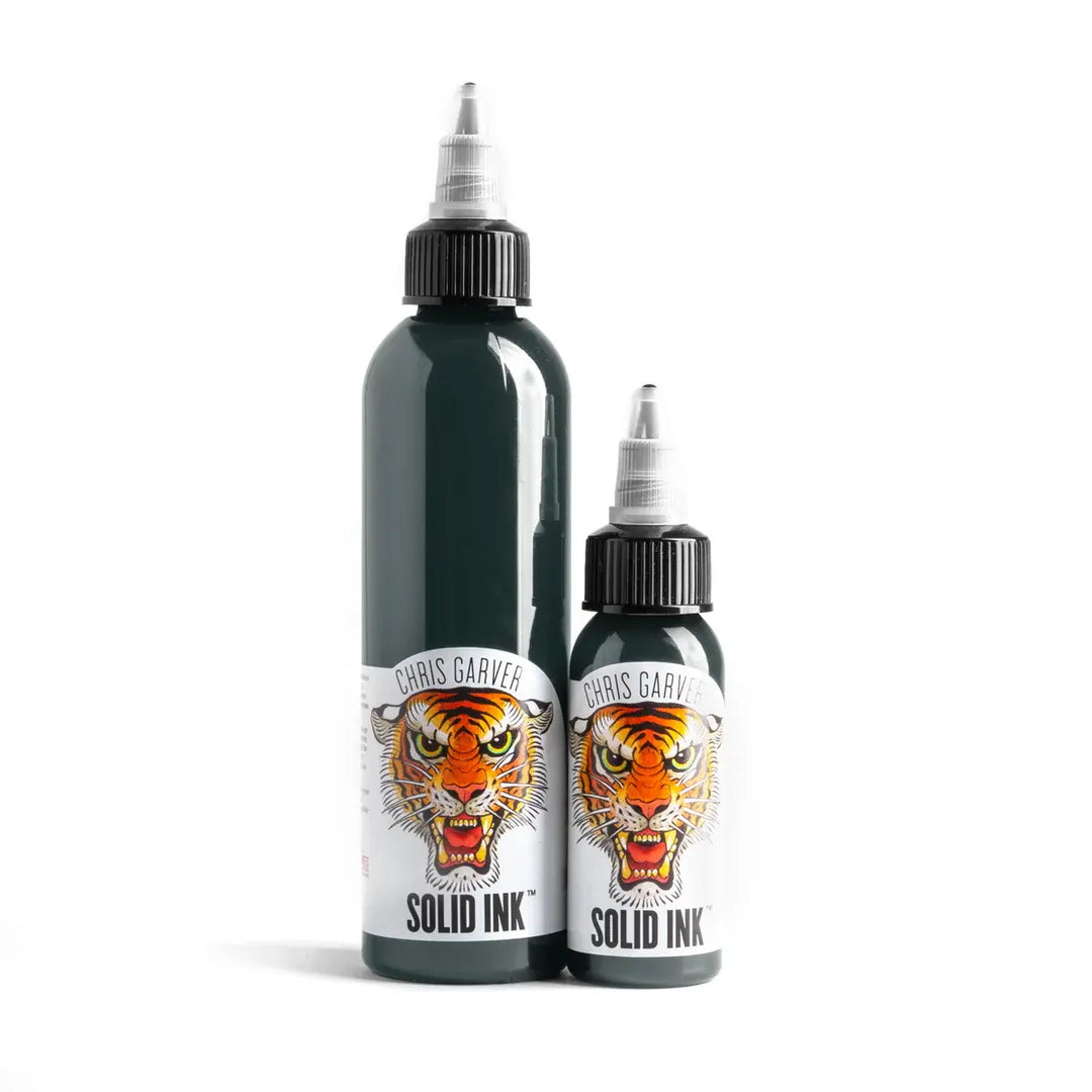 Two bottles of Chris Garver Solid Ink with tiger design labels on a white background