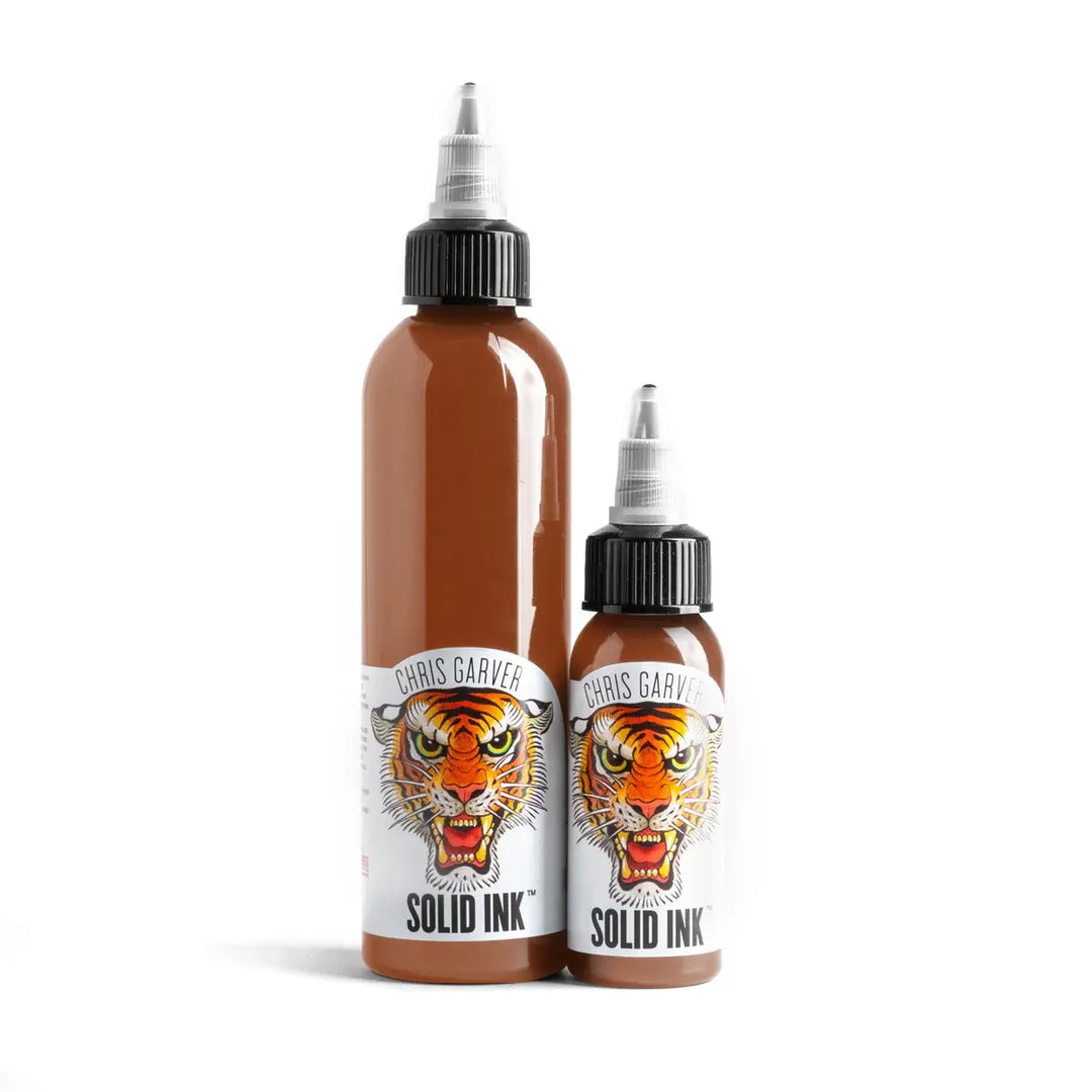 Two bottles of Chris Garver Solid Ink with tiger design labels on a white background
